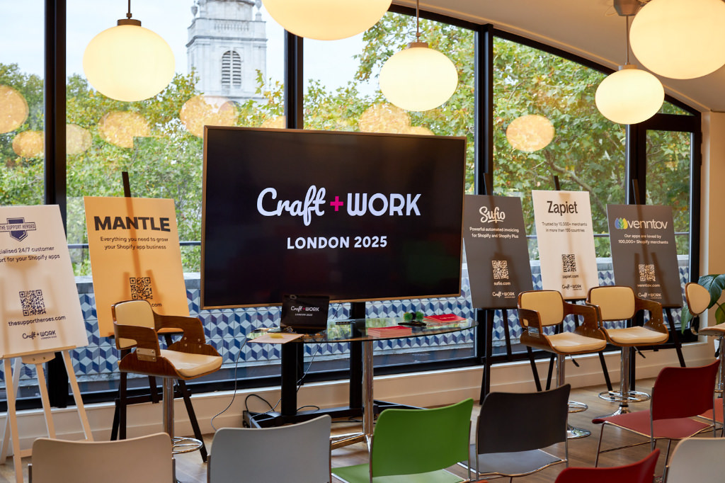 The room before people arrived. A big TV in the center showing the Craft and Work logo.