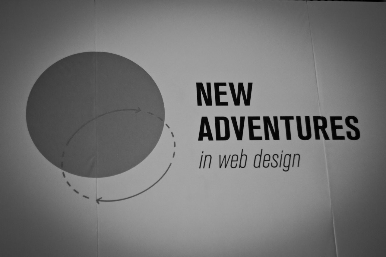 A black and white photo of the event logo stating &ldquo;NEW ADVENTURES in web design&rdquo; with some overlapping circles to the left of that.