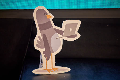 A die cut paper figure of a pidgeon.