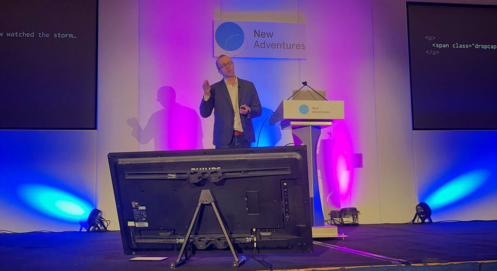 Photo showing Ethan Marcotte on stage at New Adventures conference